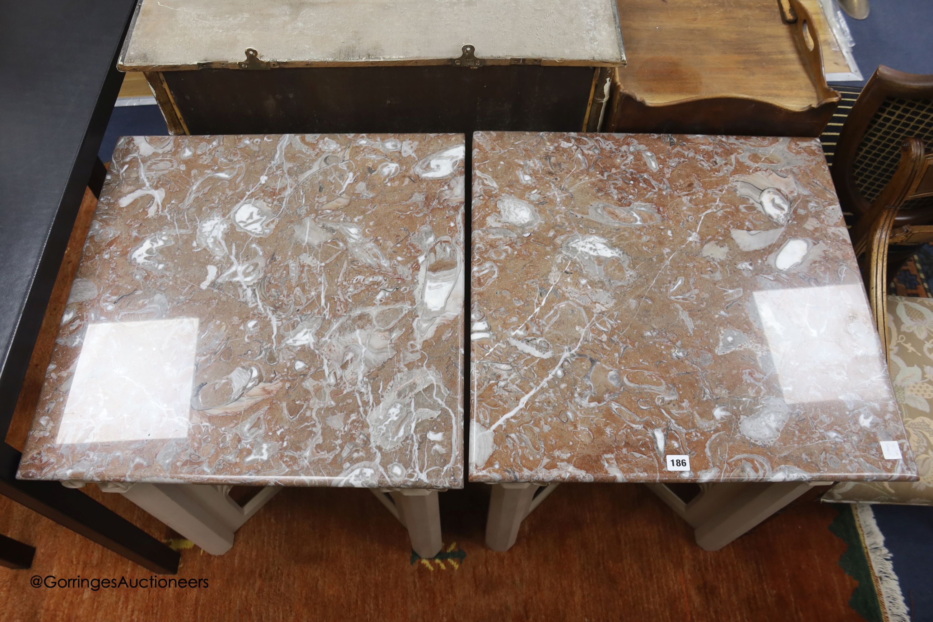 A pair of modern square tables in Gothic style, marble tops